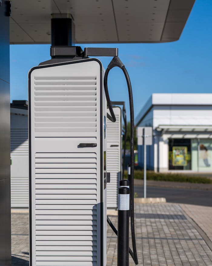 wedding-photographer-01 Electric vehicle charging station on a sunny day, showcasing sustainable urban technology.